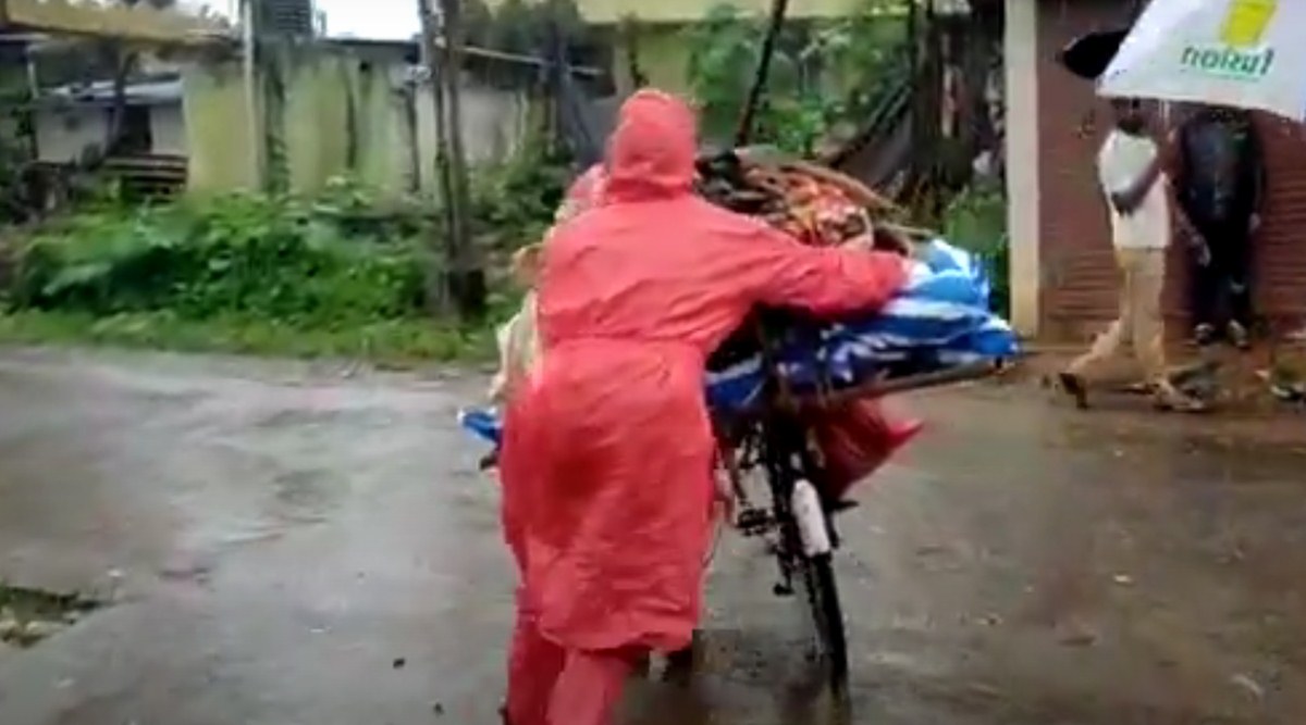 A deceased Covid-19 patient taken on a bicycle for burial