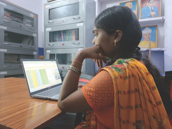 Rina Kumari works on a laptop at the JEEViKA Didi ki Library in Kulharia, Bhojpur, Bihar